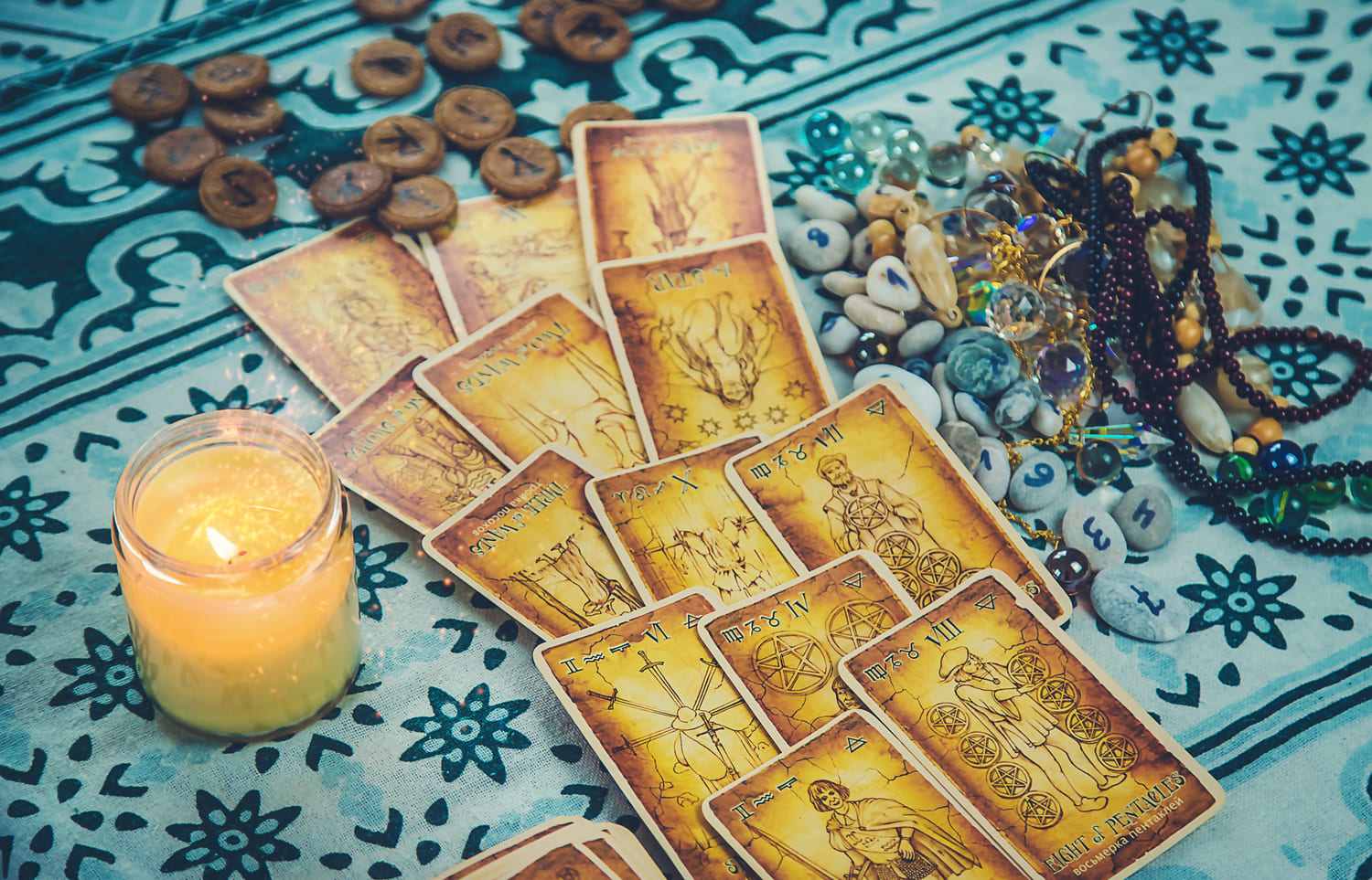 Online Psychic Reading - Tarot cards over a blue table map with mystical objects all around